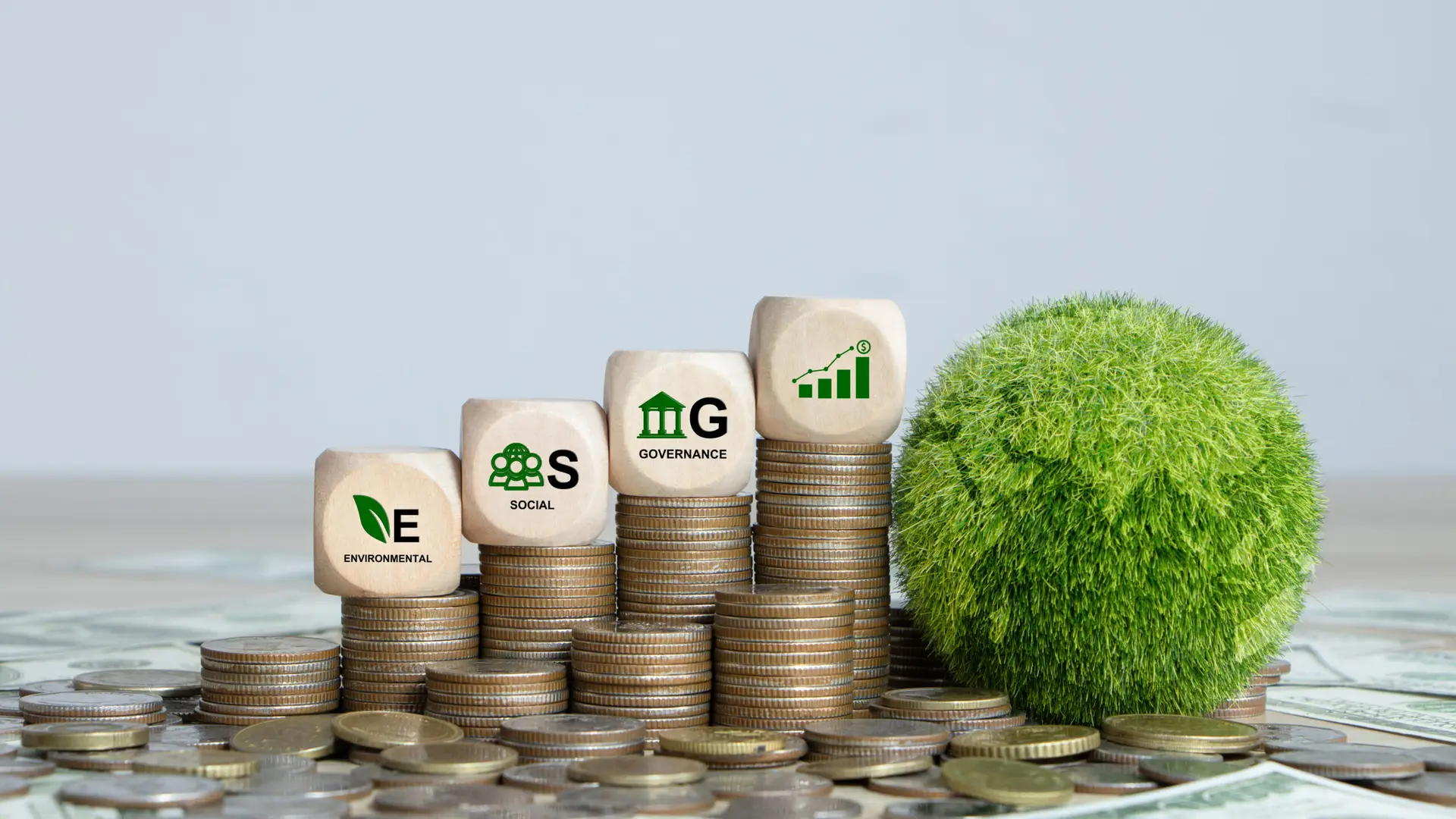Increasing columns of money topped by "ESG" dice to represent the increased financial revenues that can come with energy efficiency initiatives.